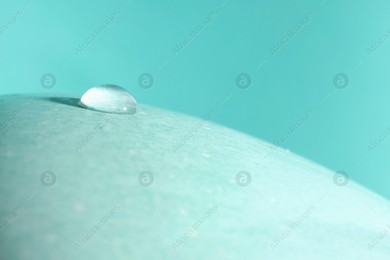 Macro photo of water drop on turquoise background. Space for text Photo of Macro photo of water drop on turquoise background. Space for text