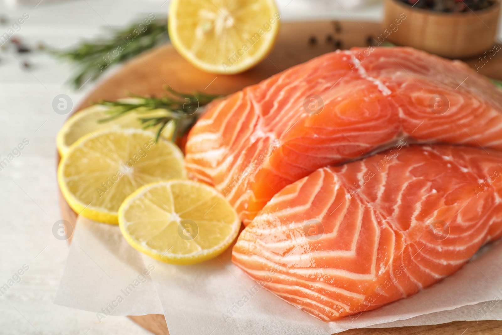 Fresh raw salmon with lemon on table. Fish delicacy Photo of Fresh raw salmon with lemon on table. Fish delicacy
