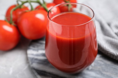 Delicious fresh tomato juice in glass on table, closeup Photo of Delicious fresh tomato juice in glass on table, closeup