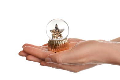 Photo of Woman holding beautiful snow globe on white background, closeup