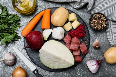 Ingredients for traditional borscht on grey table, flat lay Photo of Ingredients for traditional borscht on grey table, flat lay