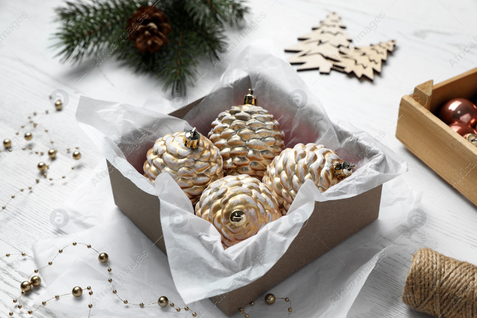 Photo of Composition with beautiful Christmas baubles on white wooden table