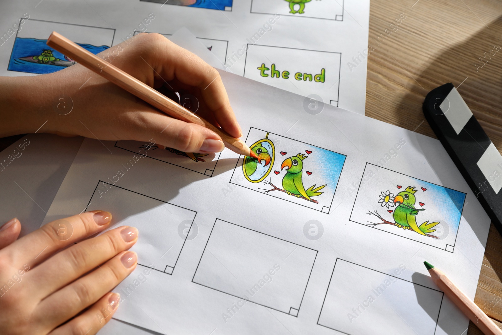 Woman drawing cartoon sketches at workplace, closeup. Pre-production process Photo of Woman drawing cartoon sketches at workplace, closeup. Pre-production process