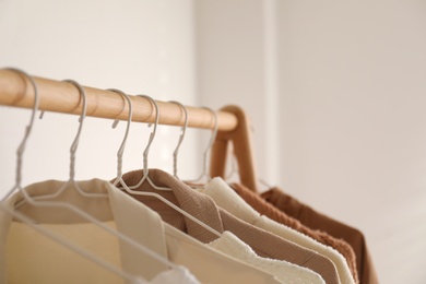 Photo of Rack with stylish women's clothes indoors. Modern interior design