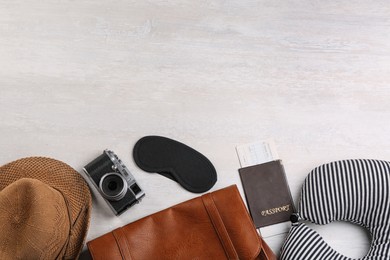 Image of Flat lay composition with striped travel pillow on light background, space for text