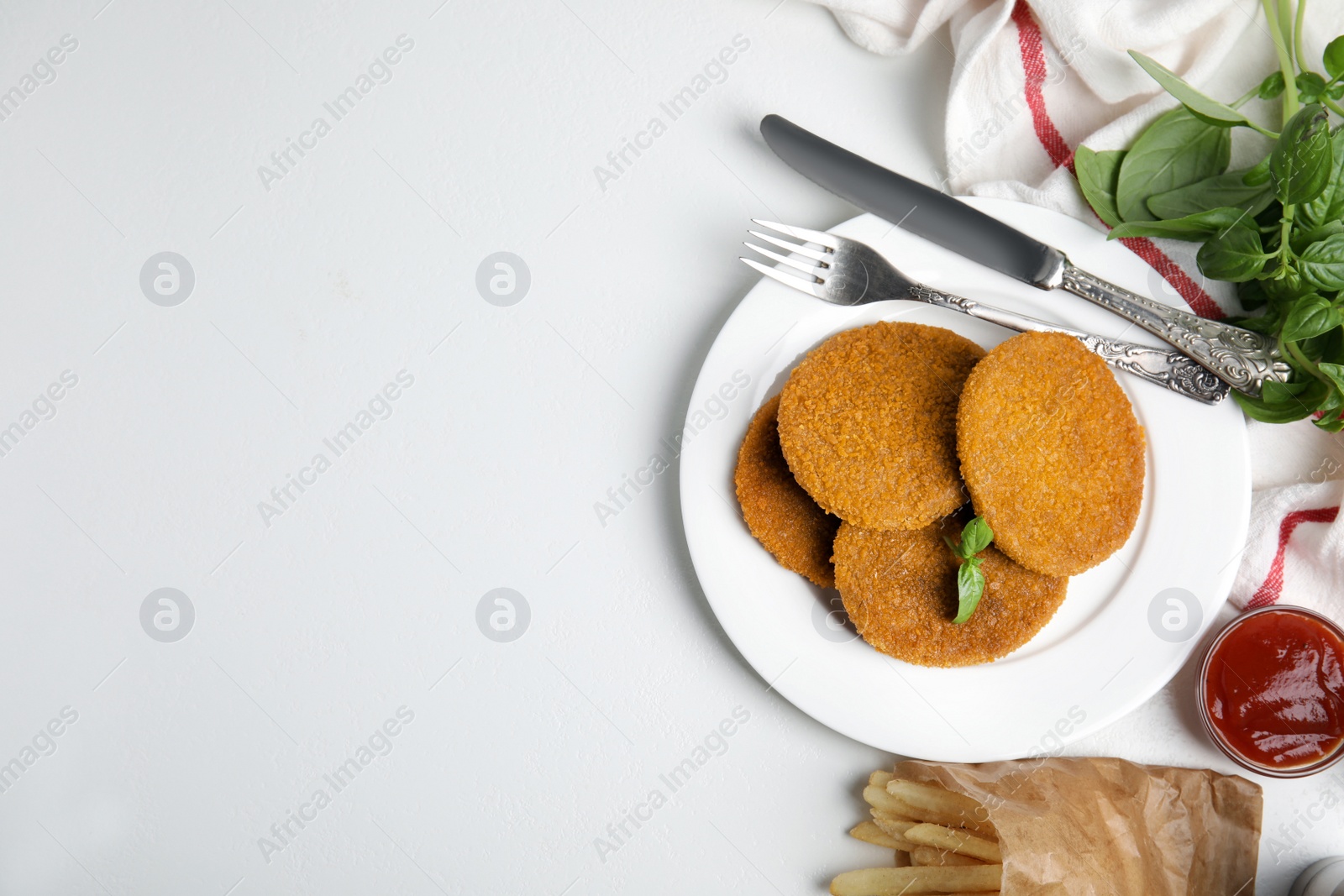 Delicious fried breaded cutlets served on white table, flat lay. Space for text Photo of Delicious fried breaded cutlets served on white table, flat lay. Space for text