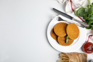 Delicious fried breaded cutlets served on white table, flat lay. Space for text Photo of Delicious fried breaded cutlets served on white table, flat lay. Space for text