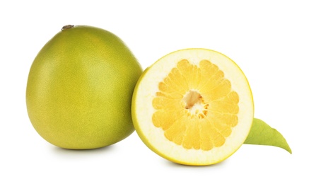 Fresh cut and whole pomelo fruits isolated on white Photo of Fresh cut and whole pomelo fruits isolated on white