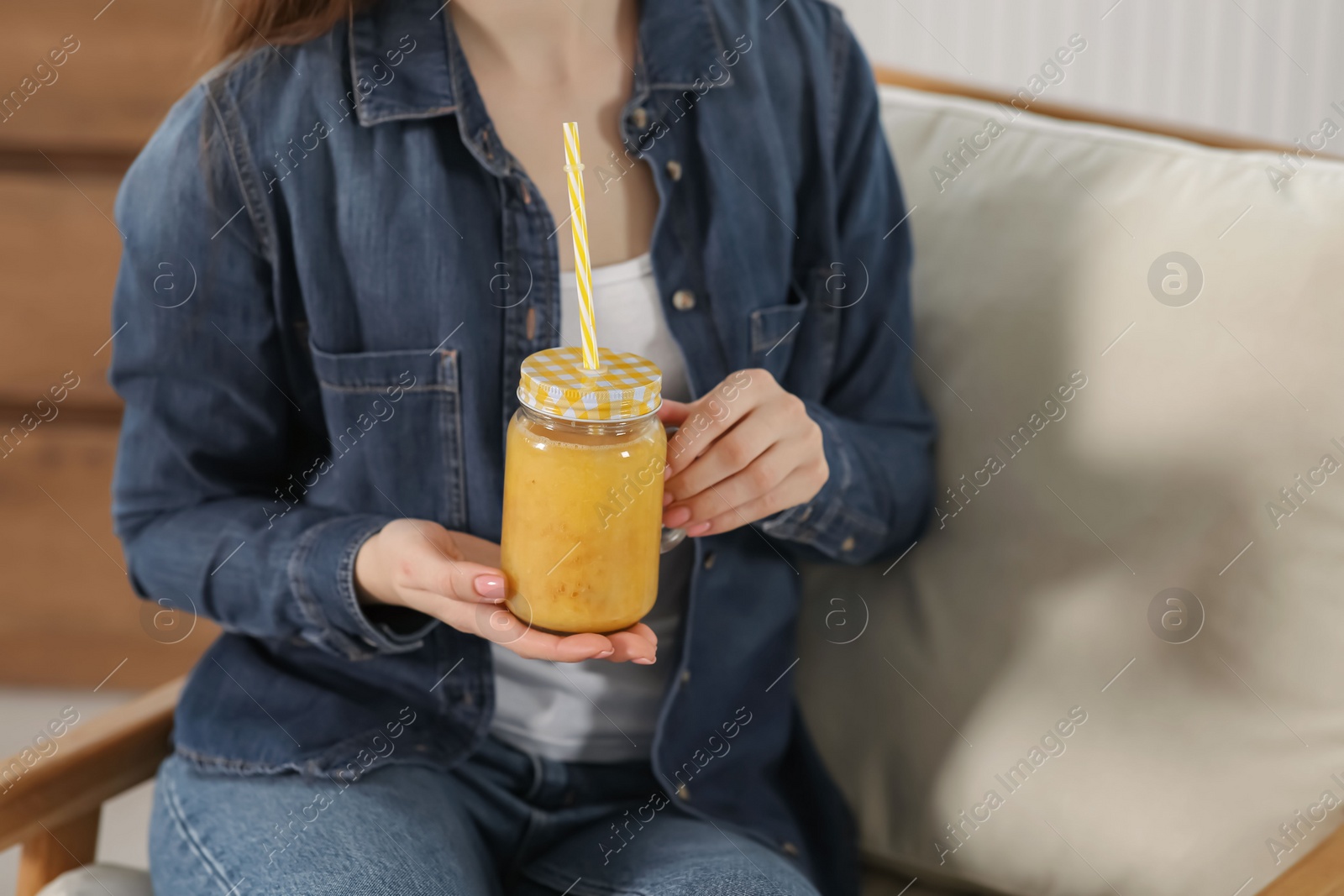 Woman with delicious smoothie indoors, closeup view Photo of Woman with delicious smoothie indoors, closeup view