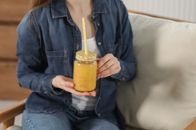 Woman with delicious smoothie indoors, closeup view Photo of Woman with delicious smoothie indoors, closeup view