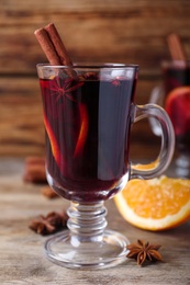 Delicious red mulled wine on wooden table, closeup Photo of Delicious red mulled wine on wooden table, closeup