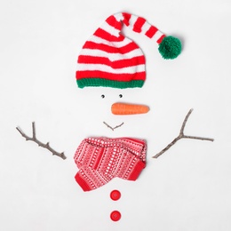 Creative snowman shape made of Santa elf's hat and different items on white background, flat lay Photo of Creative snowman shape made of Santa elf's hat and different items on white background, flat lay