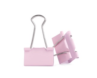 Pink binder clips on white background. Stationery item Photo of Pink binder clips on white background. Stationery item