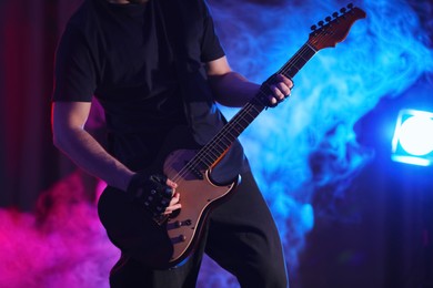 Man playing electric guitar on stage, closeup. Rock music Photo of Man playing electric guitar on stage, closeup. Rock music