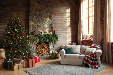 Festive interior with decorated Christmas tree and fireplace Photo of Festive interior with decorated Christmas tree and fireplace