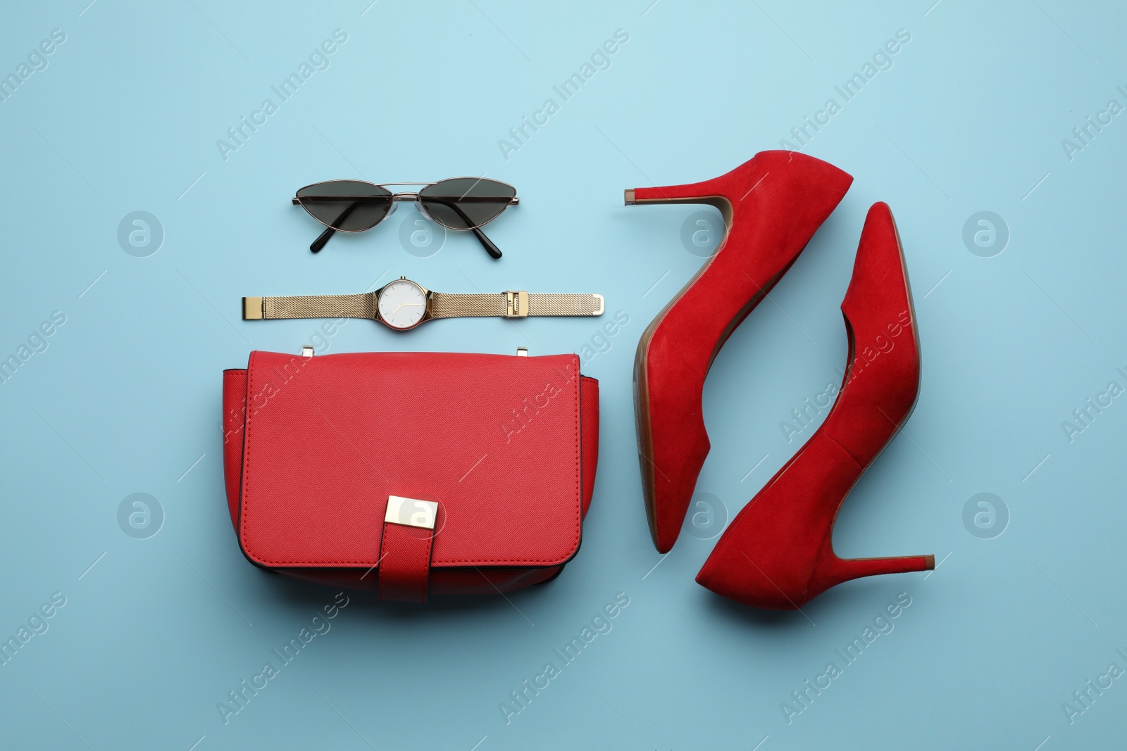 Stylish woman's bag, shoes and accessories on light blue background, flat lay Photo of Stylish woman's bag, shoes and accessories on light blue background, flat lay