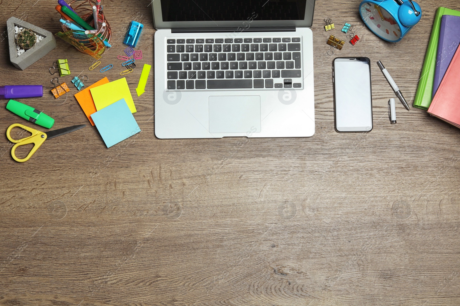 Flat lay composition with laptop, smartphone and stationery on wooden table, space for text. Designer's workplace Photo of Flat lay composition with laptop, smartphone and stationery on wooden table, space for text. Designer's workplace