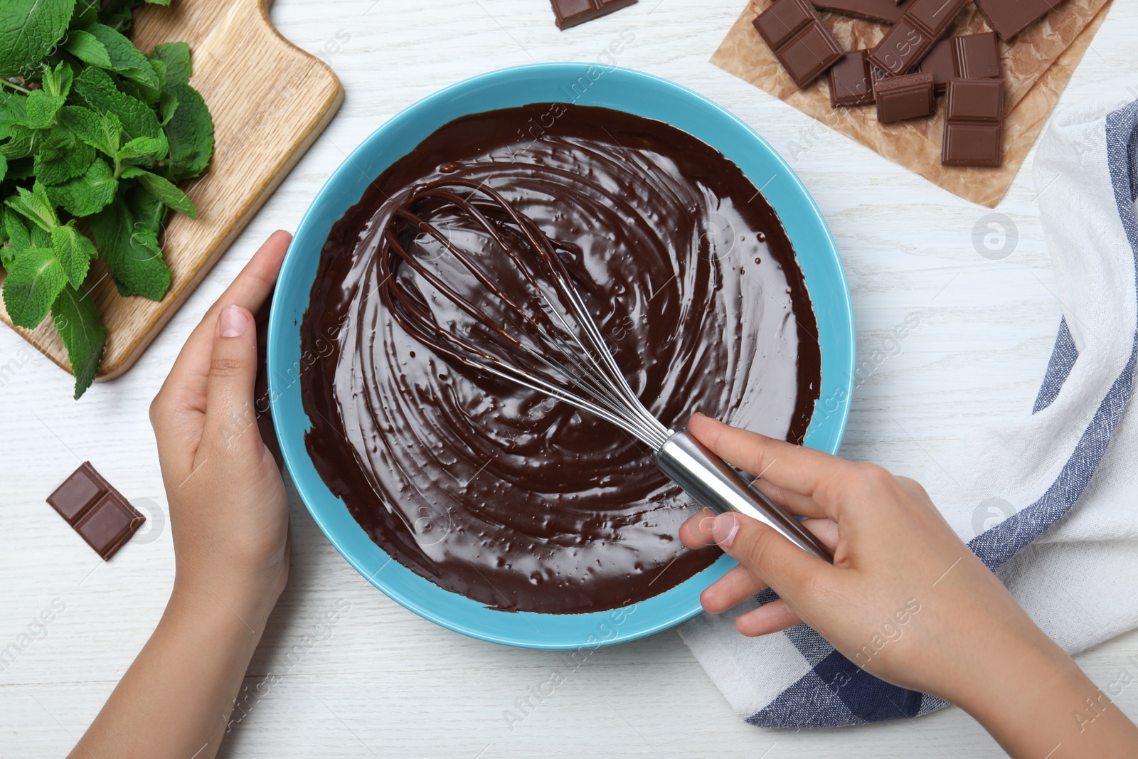 Woman making delicious chocolate cream at white wooden table, top view Photo of Woman making delicious chocolate cream at white wooden table, top view