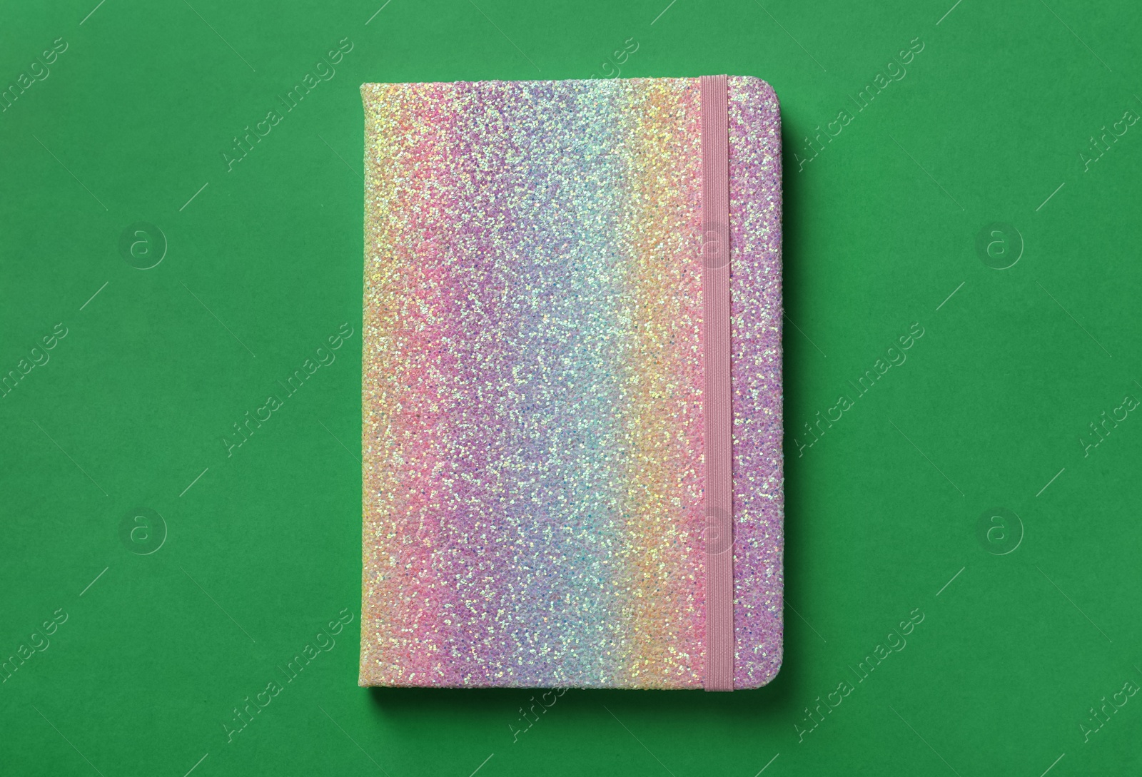 New stylish planner with hard cover on green background, top view Photo of New stylish planner with hard cover on green background, top view