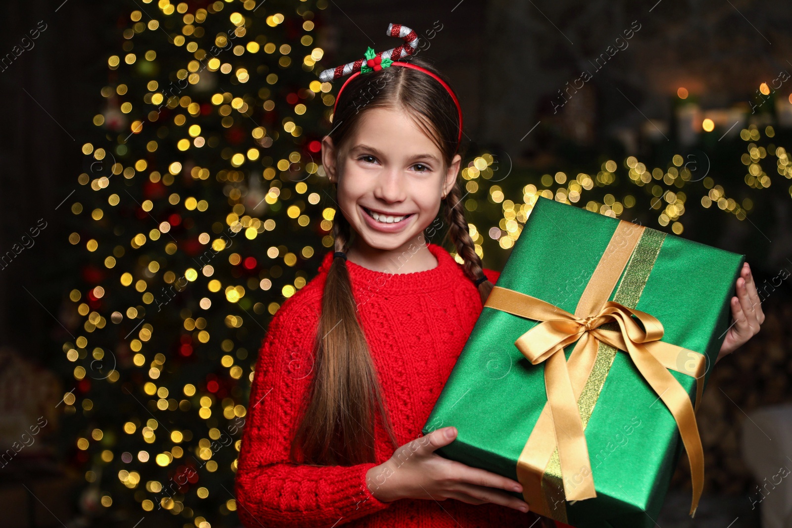 Portrait of happy child with Christmas gift at home Photo of Portrait of happy child with Christmas gift at home