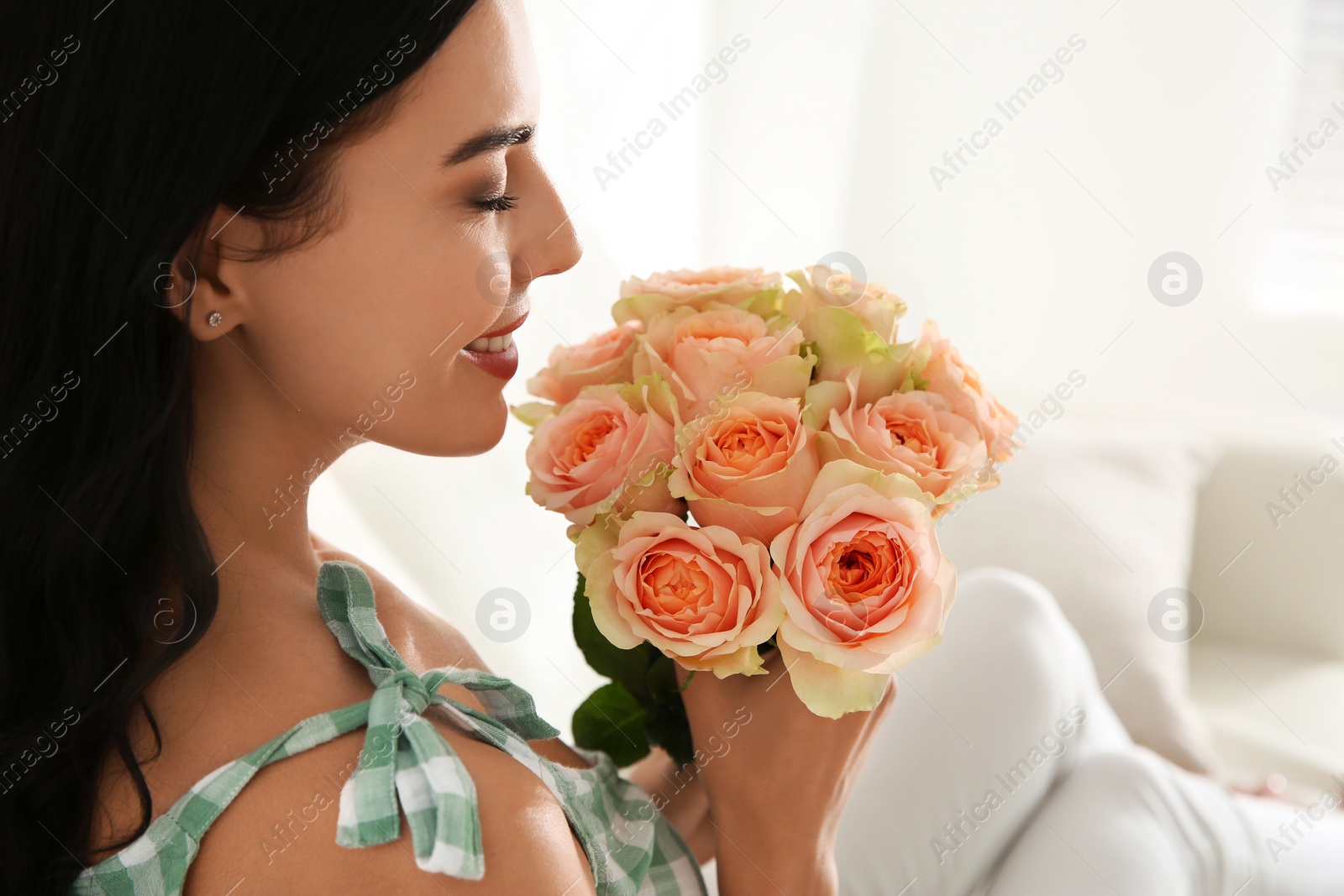 Young woman with beautiful bouquet indoors, closeup Photo of Young woman with beautiful bouquet indoors, closeup