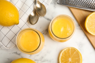 Delicious lemon curd and fresh fruits on white marble table, flat lay Photo of Delicious lemon curd and fresh fruits on white marble table, flat lay