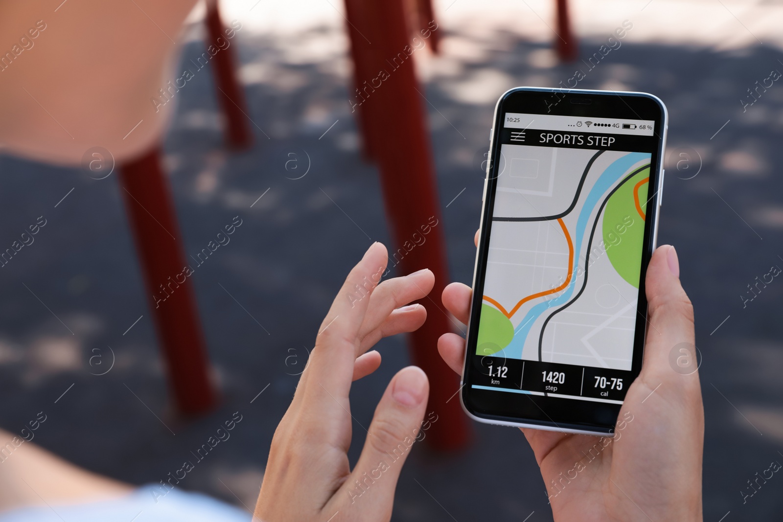 Photo of Young woman using fitness app on smartphone outdoors, closeup
