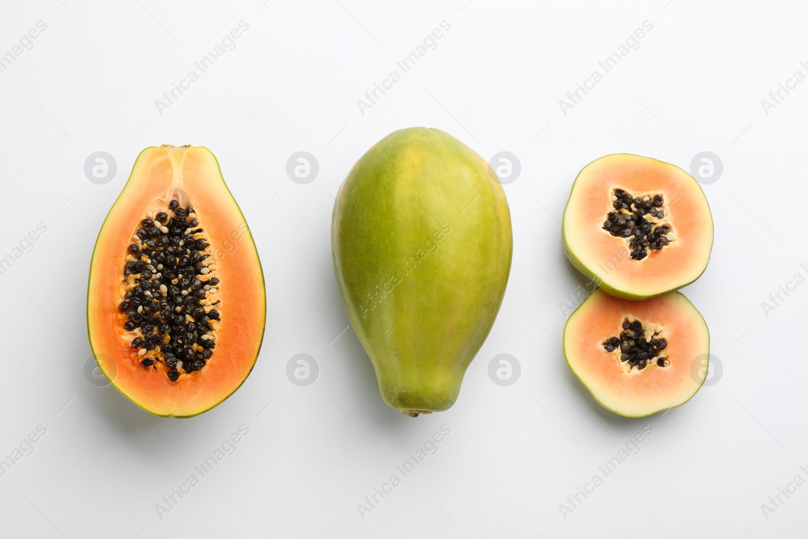 Fresh ripe papaya fruits on white background, flat lay Photo of Fresh ripe papaya fruits on white background, flat lay