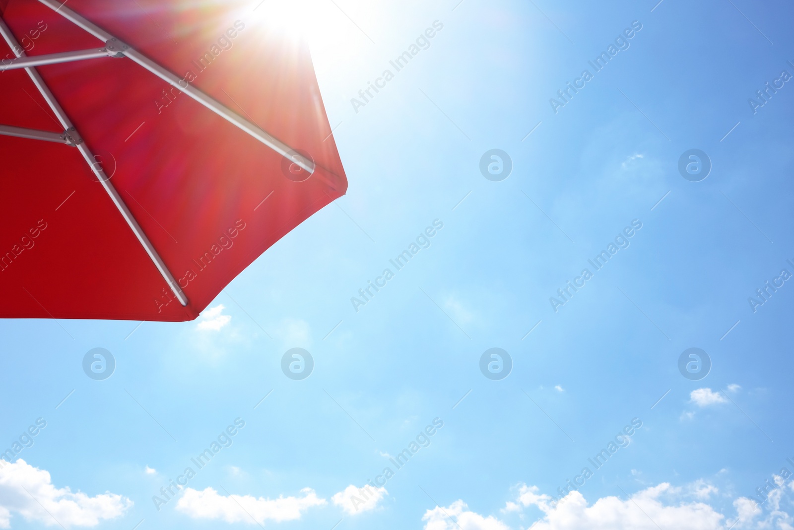 View of red umbrella and blue sky on sunny day Photo of View of red umbrella and blue sky on sunny day