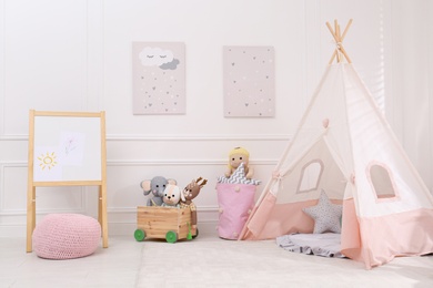 Cute child's room interior with toys, modern furniture and play tent Photo of Cute child's room interior with toys, modern furniture and play tent