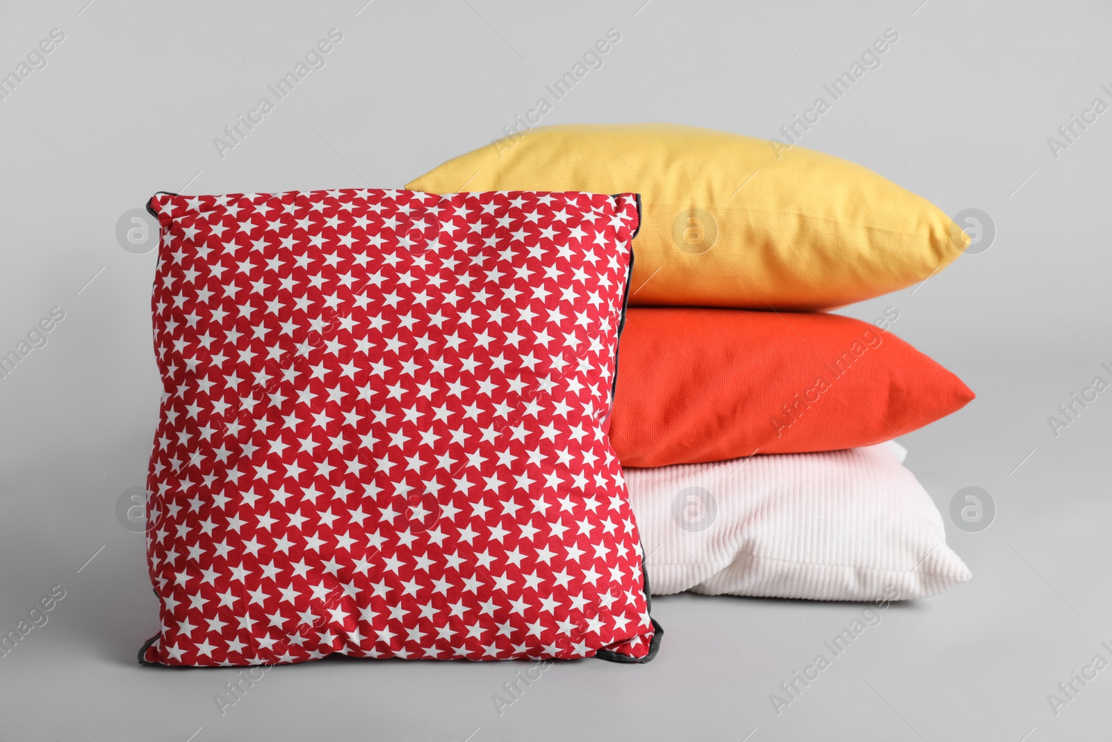 Photo of Different stylish soft pillows on grey background