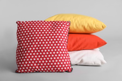 Photo of Different stylish soft pillows on grey background
