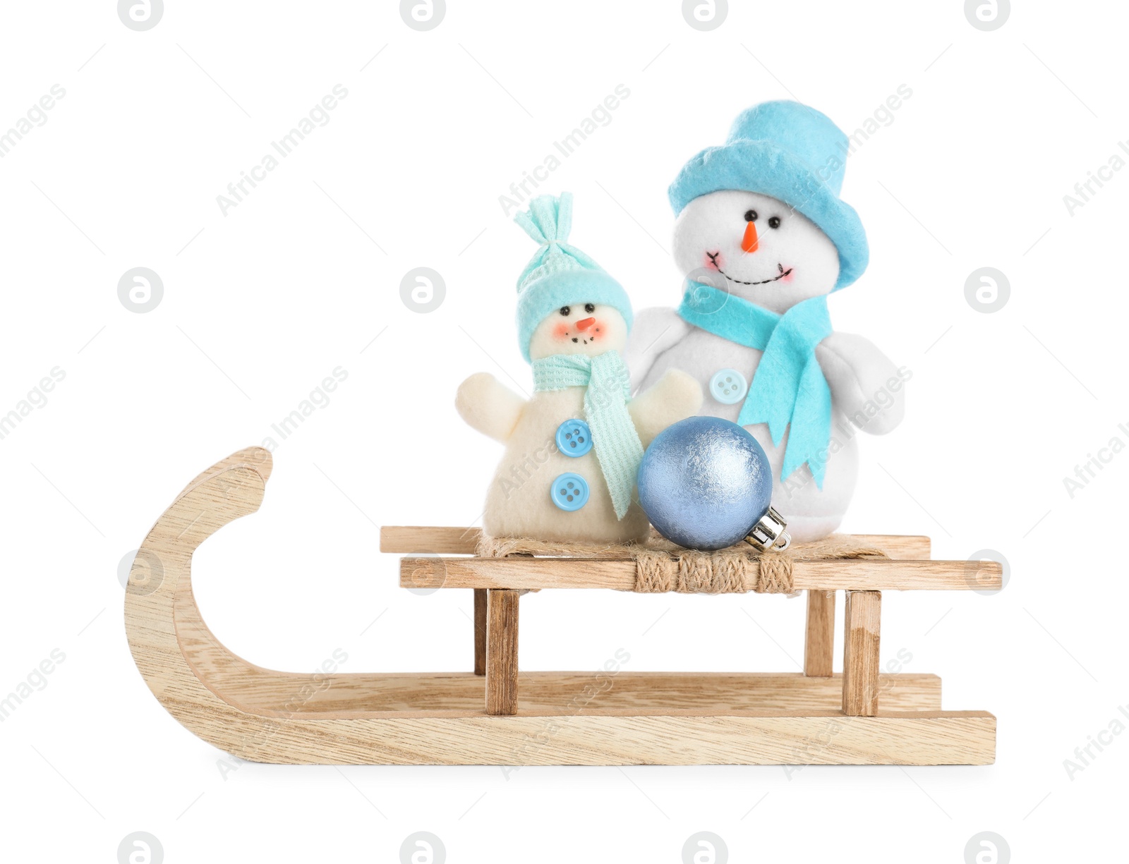 Photo of Wooden sleigh with snowmen isolated on white. Christmas holiday decor