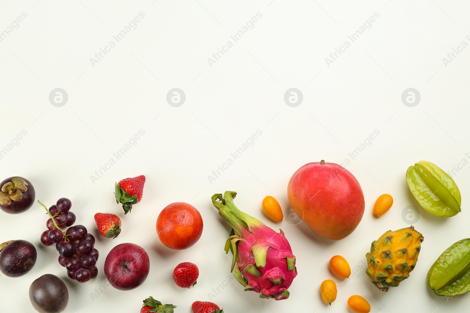 Assortment of fresh exotic fruits on white background, flat lay. Space for text Photo of Assortment of fresh exotic fruits on white background, flat lay. Space for text
