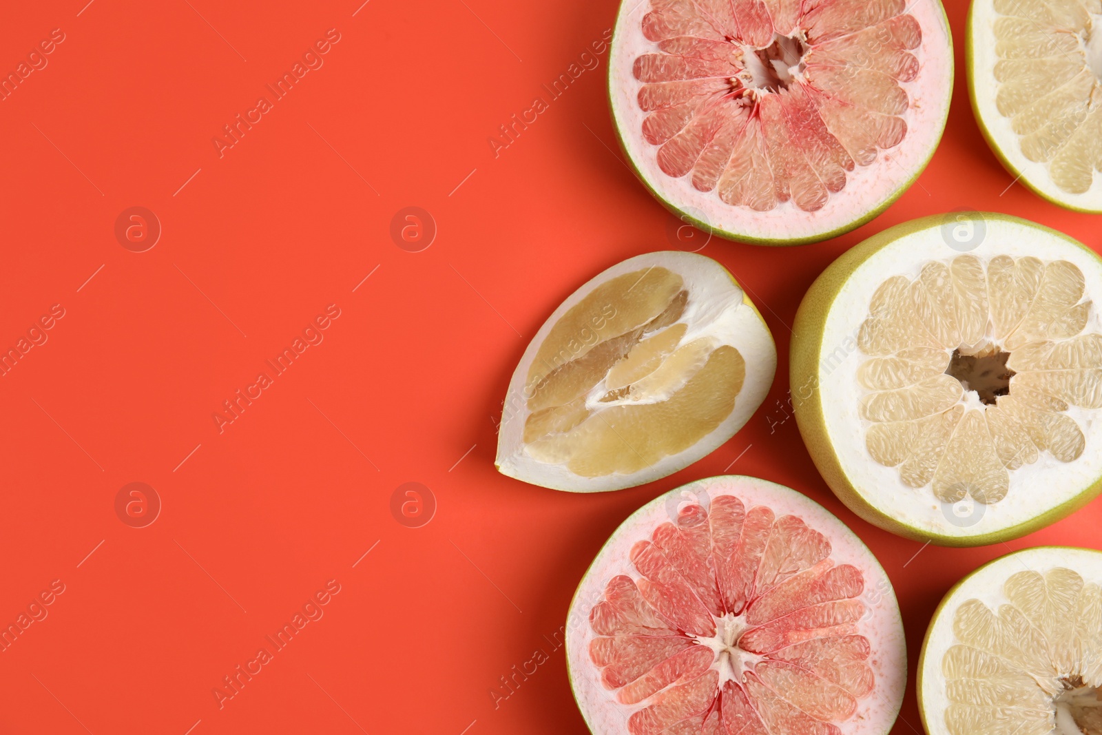 Fresh cut pomelo fruits on red background, flat lay. Space for text Photo of Fresh cut pomelo fruits on red background, flat lay. Space for text