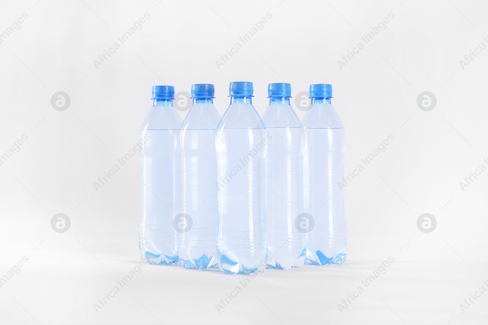 Plastic bottles with pure water on white background Photo of Plastic bottles with pure water on white background