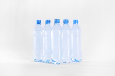 Plastic bottles with pure water on white background Photo of Plastic bottles with pure water on white background