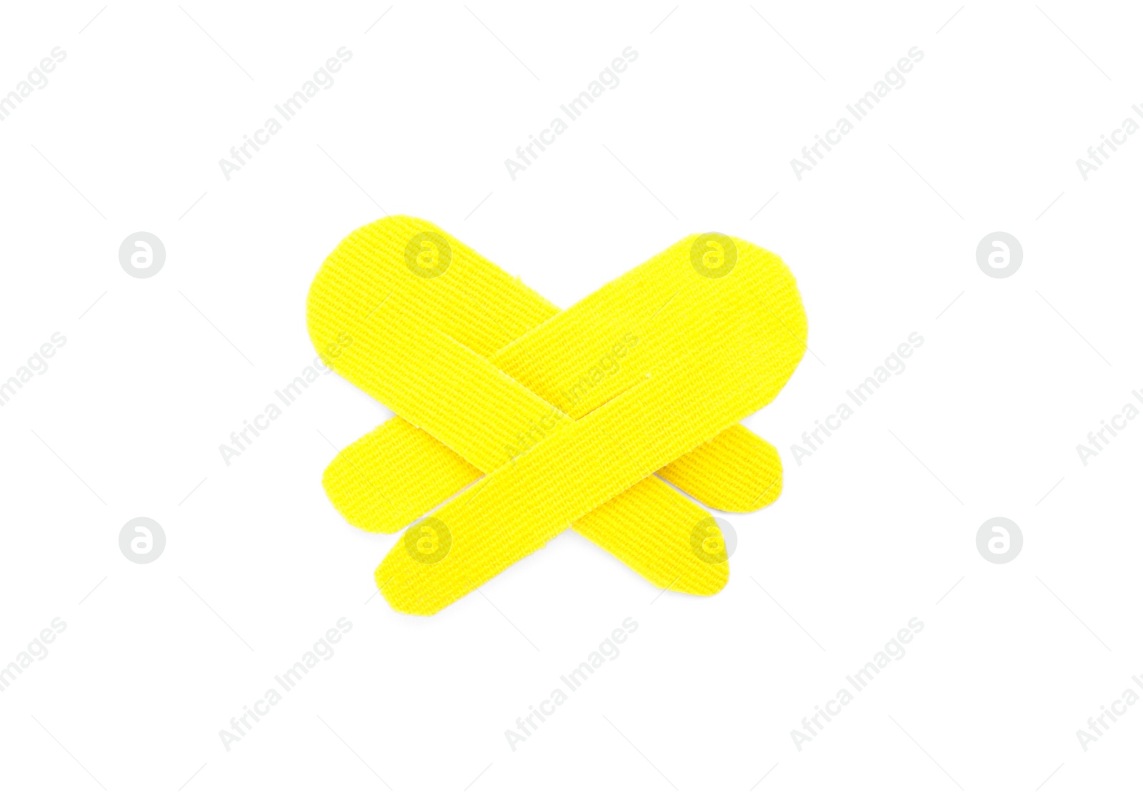 Yellow kinesio tape pieces on white background, top view Photo of Yellow kinesio tape pieces on white background, top view