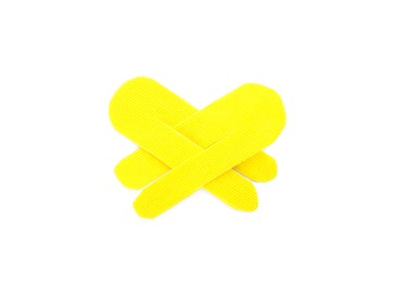 Yellow kinesio tape pieces on white background, top view Photo of Yellow kinesio tape pieces on white background, top view