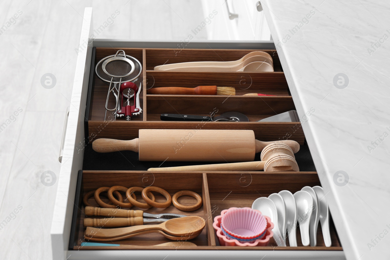 Drawer with utensil set, closeup. Order in kitchen Photo of Drawer with utensil set, closeup. Order in kitchen