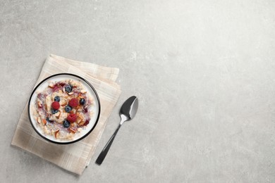 Tasty oatmeal porridge with toppings served on grey table, flat lay. Space for text Photo of Tasty oatmeal porridge with toppings served on grey table, flat lay. Space for text