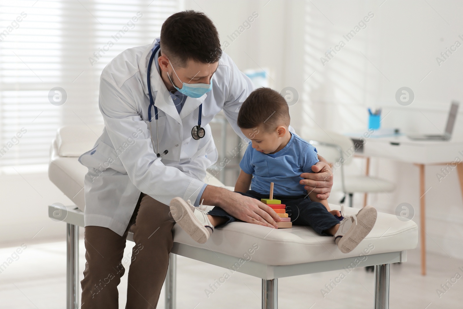 Pediatrician playing with little boy at hospital Photo of Pediatrician playing with little boy at hospital