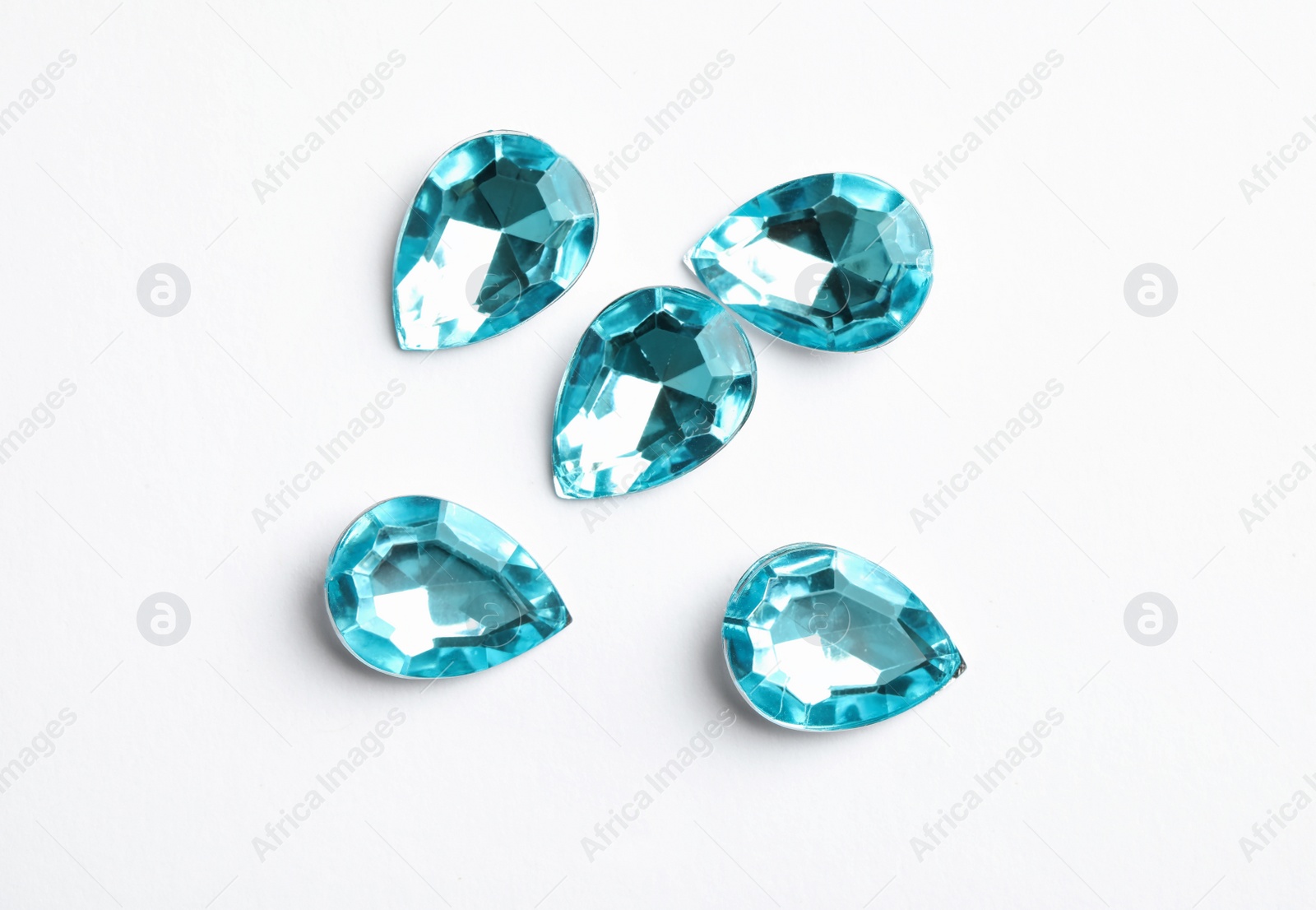 Beautiful gemstones on white background, top view Image of Beautiful gemstones on white background, top view