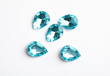 Beautiful gemstones on white background, top view Image of Beautiful gemstones on white background, top view