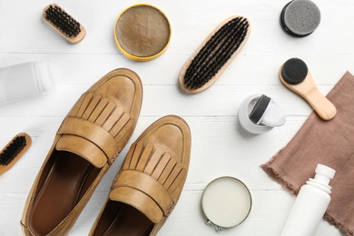 Flat lay composition with shoe care accessories and footwear on white wooden background Photo of Flat lay composition with shoe care accessories and footwear on white wooden background