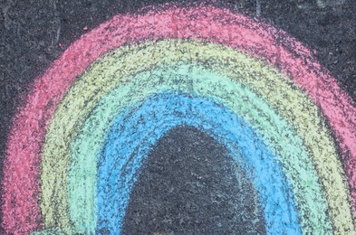 Child's chalk drawing of rainbow on asphalt, top view Photo of Child's chalk drawing of rainbow on asphalt, top view
