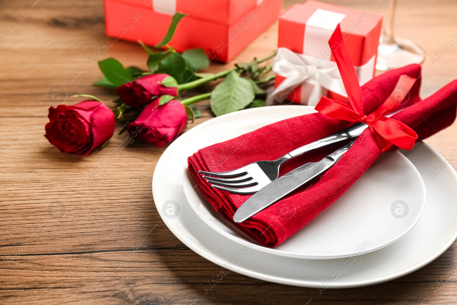 Beautiful table setting for Valentine's Day dinner on wooden background, closeup Photo of Beautiful table setting for Valentine's Day dinner on wooden background, closeup