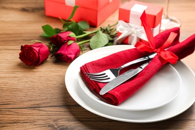 Beautiful table setting for Valentine's Day dinner on wooden background, closeup Photo of Beautiful table setting for Valentine's Day dinner on wooden background, closeup