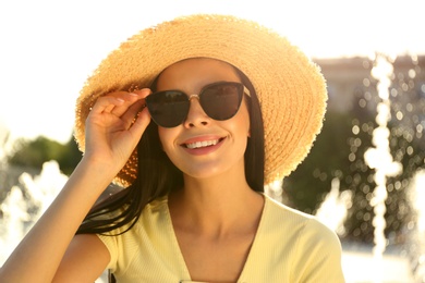 Beautiful young woman wearing stylish sunglasses outdoors Photo of Beautiful young woman wearing stylish sunglasses outdoors