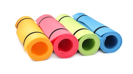Colorful rolled camping or exercise mats on white background Photo of Colorful rolled camping or exercise mats on white background